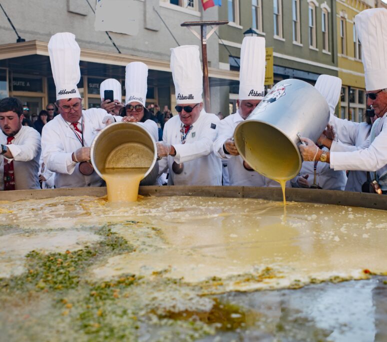 Pouring of eggs at the Giant Omelette Celebration.